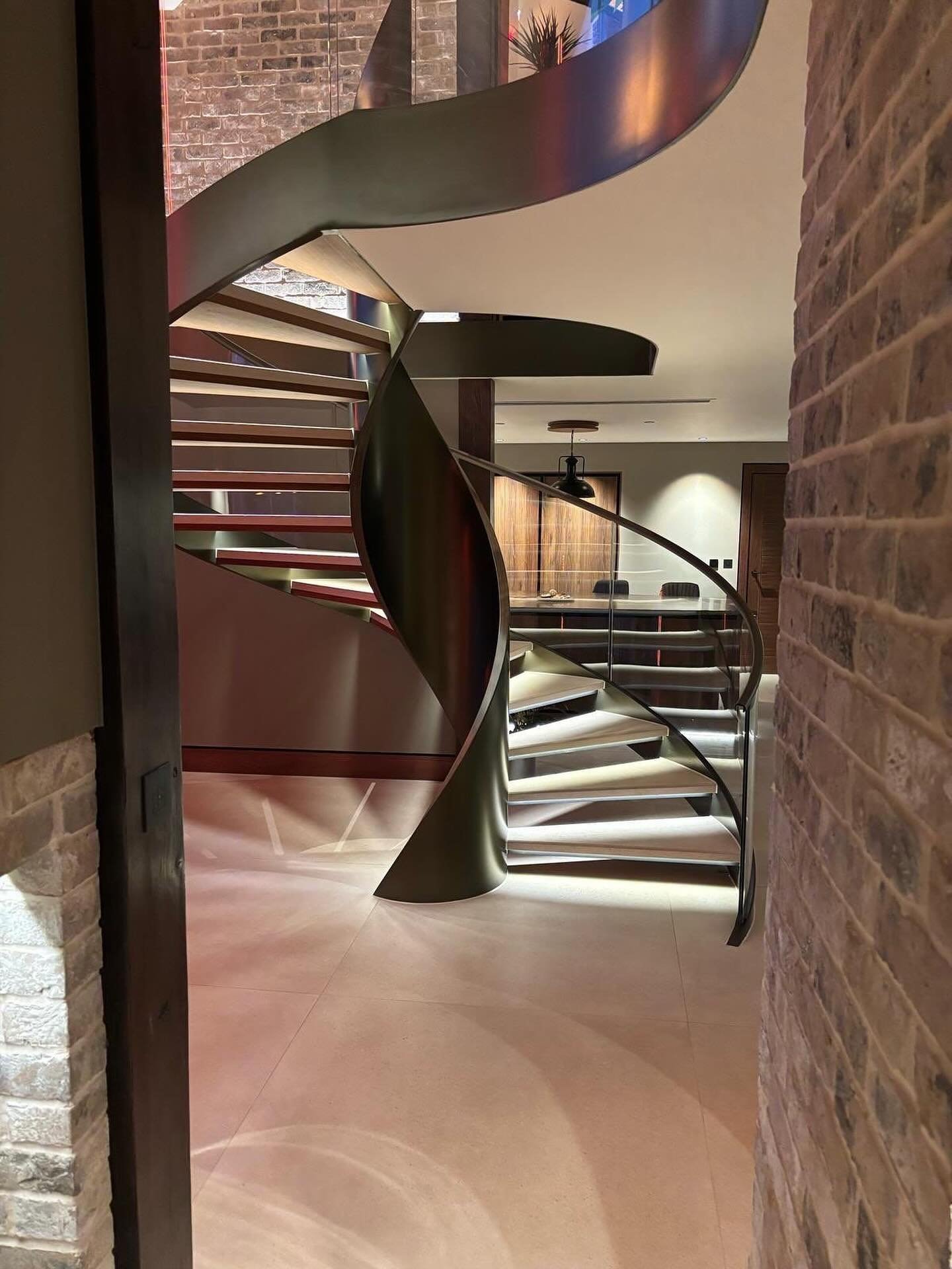 Curved glass and spiral staircases share more than just graceful lines. They require precise coordination to create something truly seamless. We regularly work alongside staircase designers to ensure that balustrading follows every twist and contour perfectly. If your project includes a sweeping staircase, we can help turn bold ideas into buildable details. #CurvedGlass #ArchitecturalGlazing #StaircaseDesign #GlassBalustrades #HighEndInteriors #PrecisionGlass
