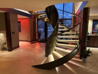A previous installation of a frameless glass balustrade to a curved staircase, secured within a discreet side-fixed channel and capping handrail to the top.By fixing the glass to the face of the staircase stringer, we were able to keep the stair width clear while achieving a clean, uninterrupted line of glass from tread to landing. The result is a light, open feel that enhances both the architecture and the natural flow of light through the space.Each panel was manufactured to suit the exact site dimensions and radius of the curve, ensuring a precise fit and a refined finish that complements the surrounding materials.#framelessglass #glassbalustrade #staircase design #bespokeglass #structuralglass luxuryinteriors modernstaircase architecturalglass glassdesign premiumhomes
