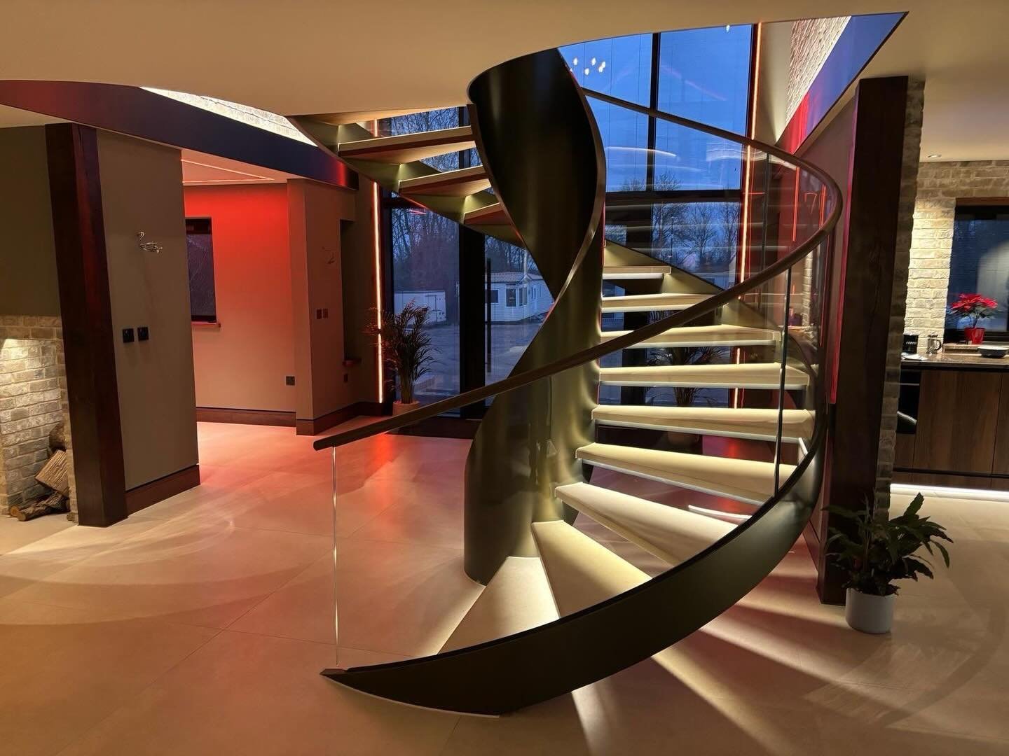 A previous installation of a frameless glass balustrade to a curved staircase, secured within a discreet side-fixed channel and capping handrail to the top.By fixing the glass to the face of the staircase stringer, we were able to keep the stair width clear while achieving a clean, uninterrupted line of glass from tread to landing. The result is a light, open feel that enhances both the architecture and the natural flow of light through the space.Each panel was manufactured to suit the exact site dimensions and radius of the curve, ensuring a precise fit and a refined finish that complements the surrounding materials.#framelessglass #glassbalustrade #staircase design #bespokeglass #structuralglass luxuryinteriors modernstaircase architecturalglass glassdesign premiumhomes