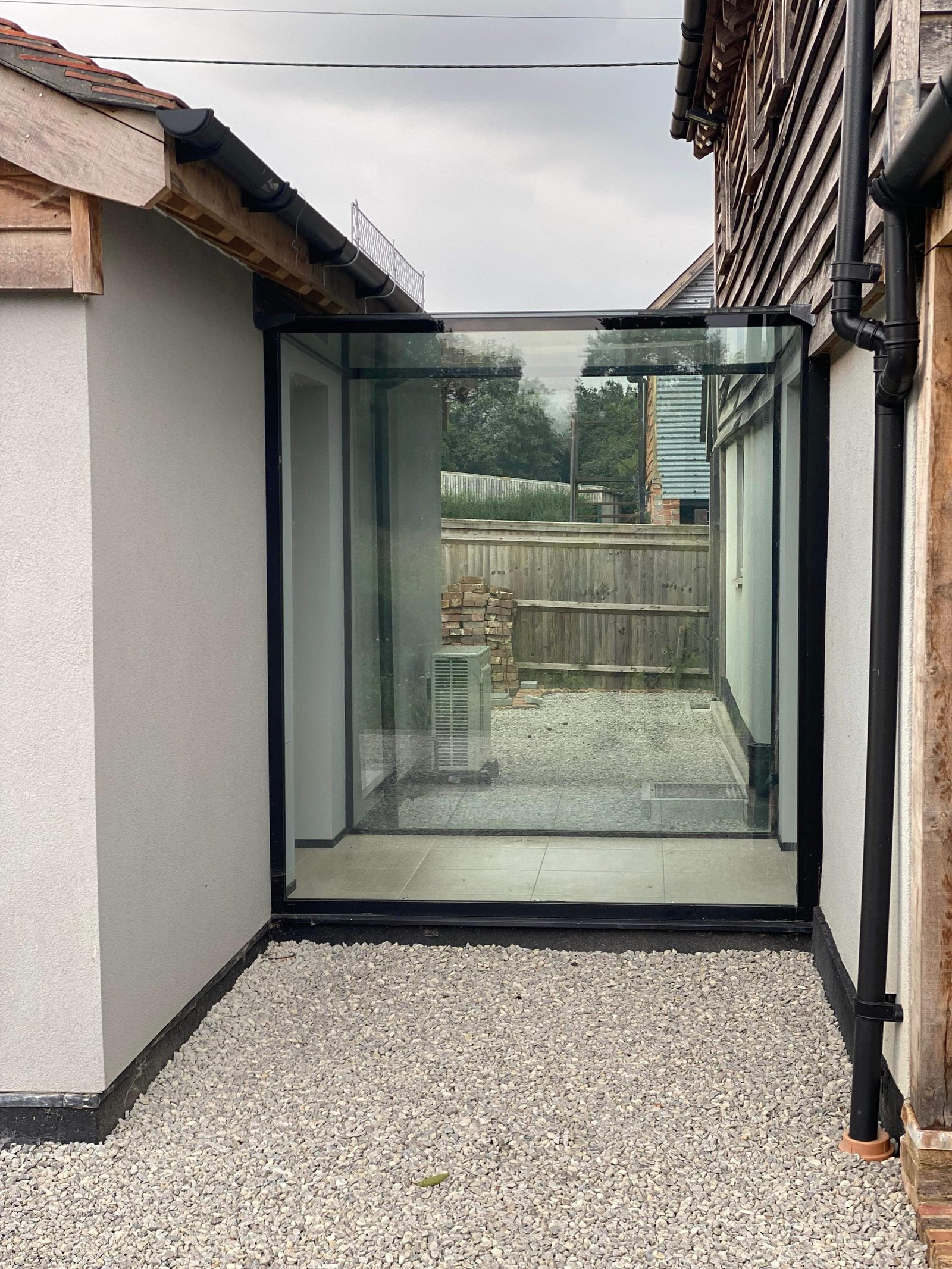 In conclusion, a frameless glass link offers more than a physical connection between spaces. It creates continuity, introduces natural light, and maintains a clear architectural distinction between old and new.By removing heavy framing and visible structure, the focus remains on the surrounding materials and landscape. The result is a clean, understated transition that feels considered rather than imposed.For period renovations, contemporary extensions, or complex linking structures, a bespoke frameless glass link provides clarity, lightness and design flexibility where standard systems often fall short.If you are exploring how to connect two structures without compromising character or light, a thoughtfully designed glass link is often the most refined solution.Our next focus will be on oversized double glazing, rooflights and walk-on glass!#GlassLink #FramelessGlass #StructuralGlazing #ArchitecturalGlass #LuxuryHomes ContemporaryArchitecture DesignDetail GlazedExtension BespokeDesign HighEndHomes