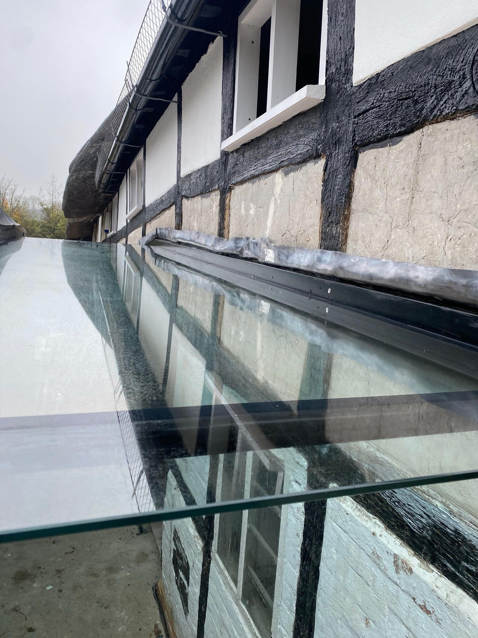How does a glass to glass joint look on a frameless glass link?It is a detail we are often asked about during the design stage.In most frameless glass links, the panes are joined using structural silicone to create a slim, consistent bond line. When combined with stepped edges and silicone backpainting, the joint reads as a fine shadow line rather than a visible seam. The result is clean and visually quiet, allowing the transparency of the link to remain the focus.From inside, the junction appears subtle and uniform. From outside, reflections across the glazing further soften the line, particularly when pane sizes and setting out have been carefully considered.These details may seem simple, but achieving a refined finish requires careful coordination, precise fabrication and experienced installation.If you are developing a glass link and would like to review joint detailing at concept stage, we are happy to discuss practical solutions that support both design intent and buildability.#architects #architecturalglass #fractlessdesign #glasslink #structuralglazing framelessglass detaildesign highendresidential commercialarchitecture glazingspecialist