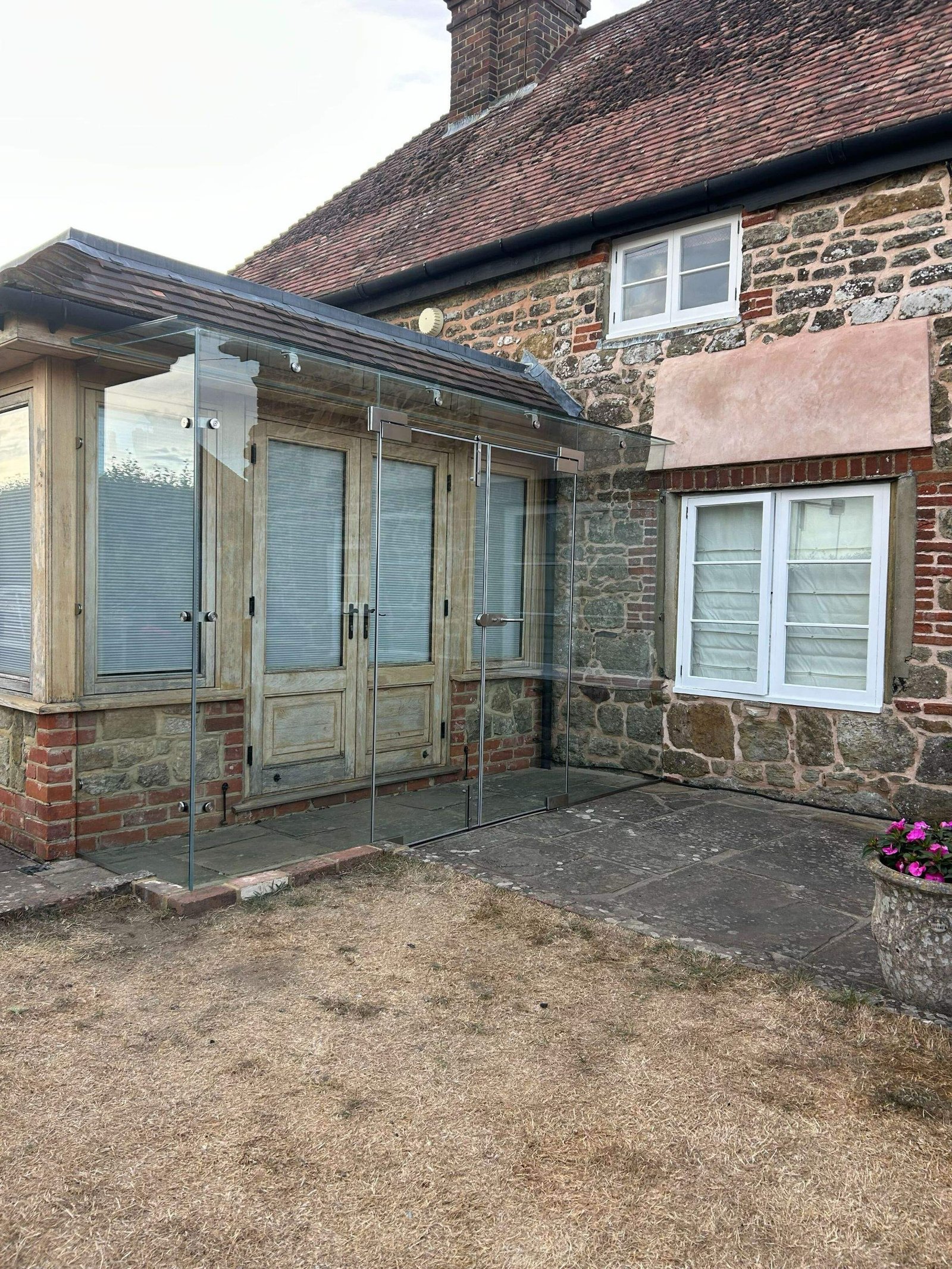 A recent frameless glass box porch, designed to create a clean, contemporary entrance while allowing natural light to flow through the space.With minimal framing and precise glass interfaces, the finished porch provides shelter without adding visual weight to the architecture.#FramelessGlass #GlassPorch #ArchitecturalGlazing #StructuralGlass #GlassEntrance BespokeGlazing ContemporaryArchitecture PrecisionGlass ArchitecturalDetails LuxuryHomes